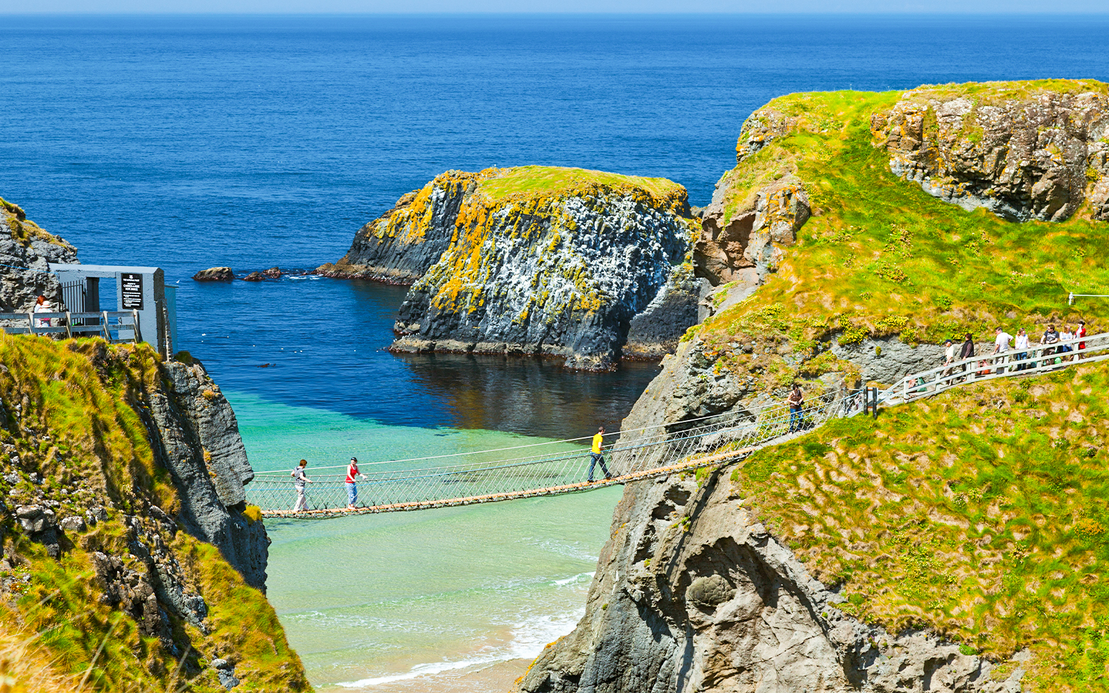 Carrick-A-Rede Rope Bridge spanning cliffs with ocean view, near Belfast, Northern Ireland.