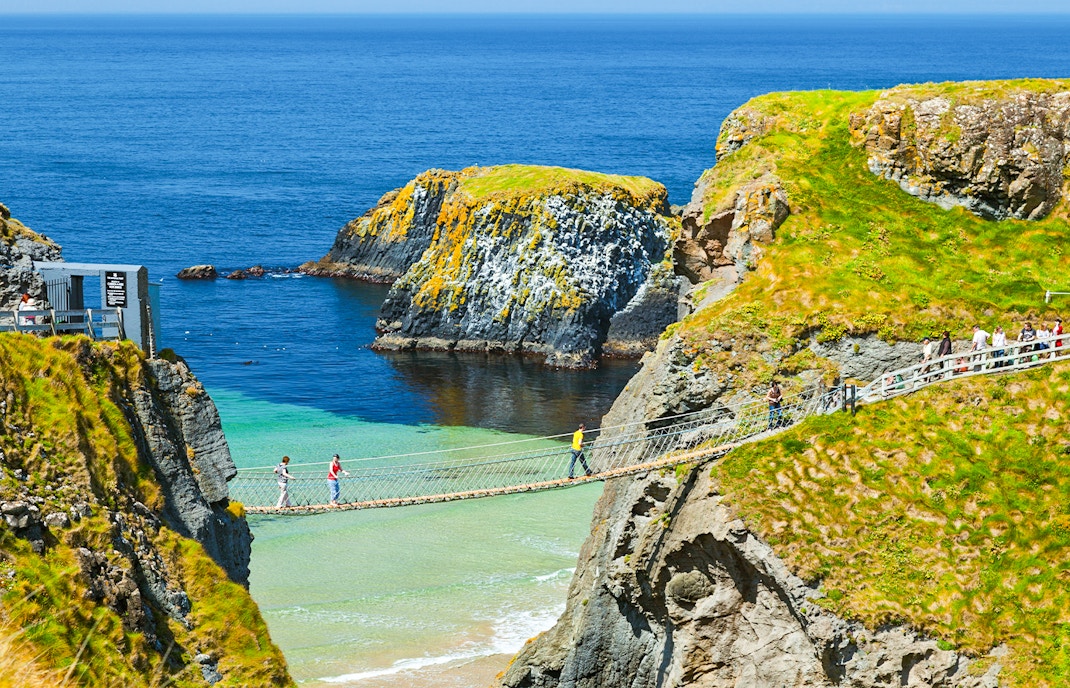 Carrick-A-Rede Rope Bridge spanning cliffs with ocean view, near Belfast, Northern Ireland.