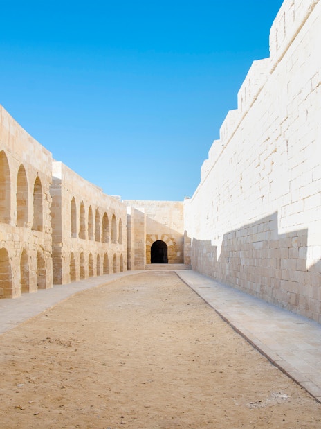 Street inside Qaitbay Citadel, Alexandria, Egypt, with stone walls and arches.