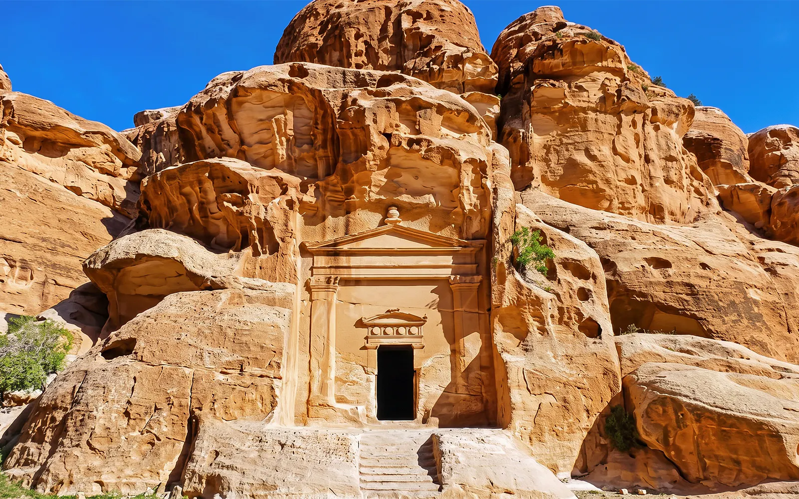 Petra rock-cut architecture in Jordan on a sunny day.