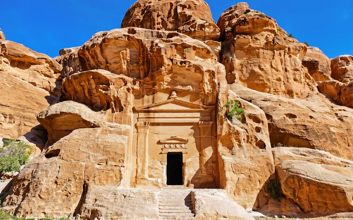 Petra rock-cut architecture in Jordan on a sunny day.