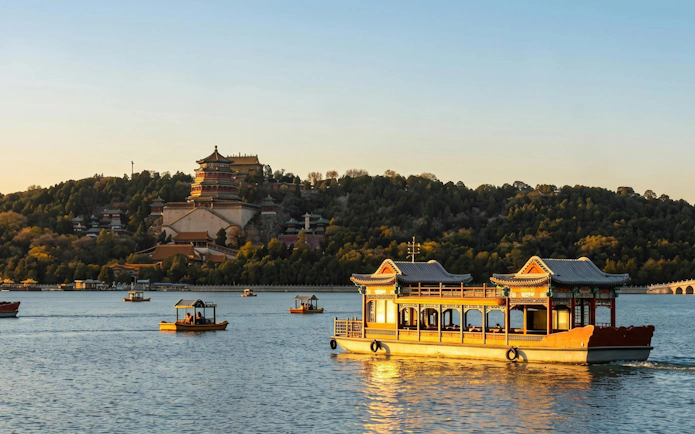 Boats on Kunming Lake with Summer Palace in Beijing during a day tour.
