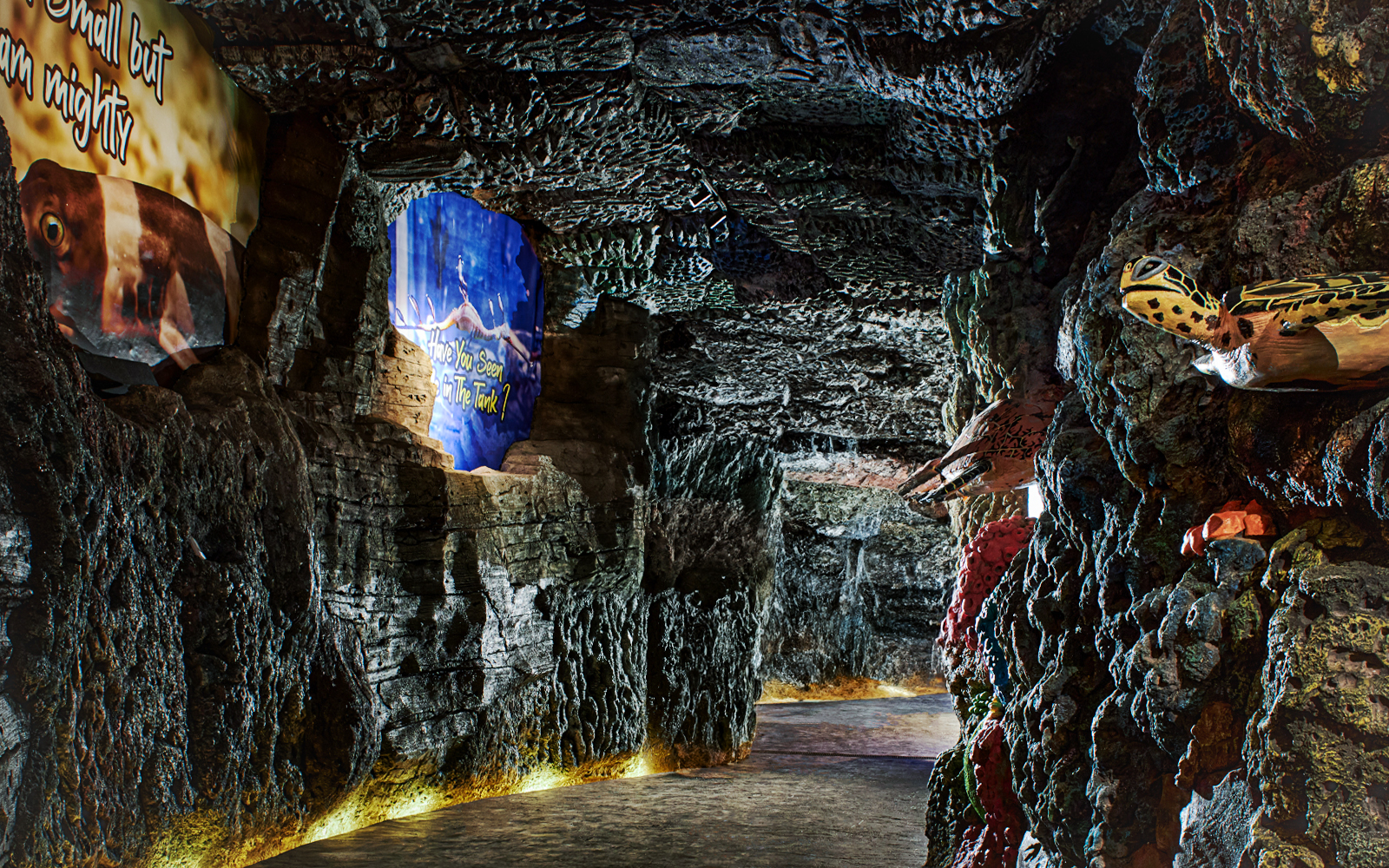 Underground marine-themed exhibit at Bali Safari with colorful rock formations and sea creature displays.