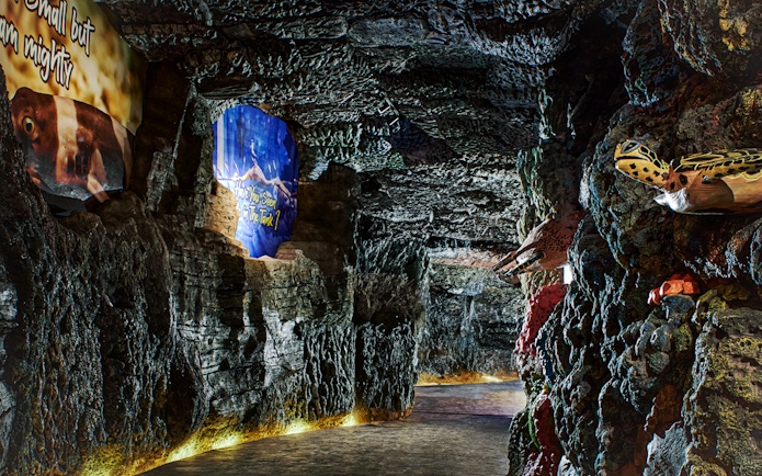 Underground marine-themed exhibit at Bali Safari with colorful rock formations and sea creature displays.