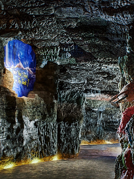 Underground marine-themed exhibit at Bali Safari with colorful rock formations and sea creature displays.