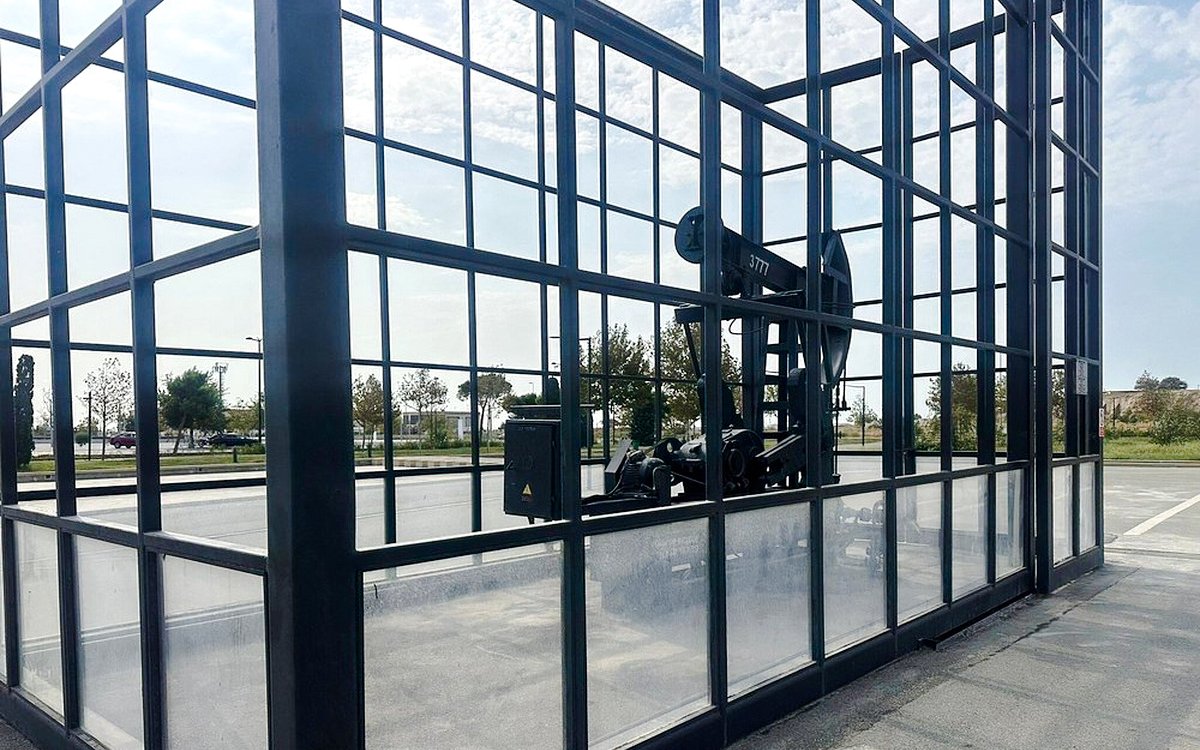 Oil pumpjack enclosed in glass at Gobustan National Park, Azerbaijan.