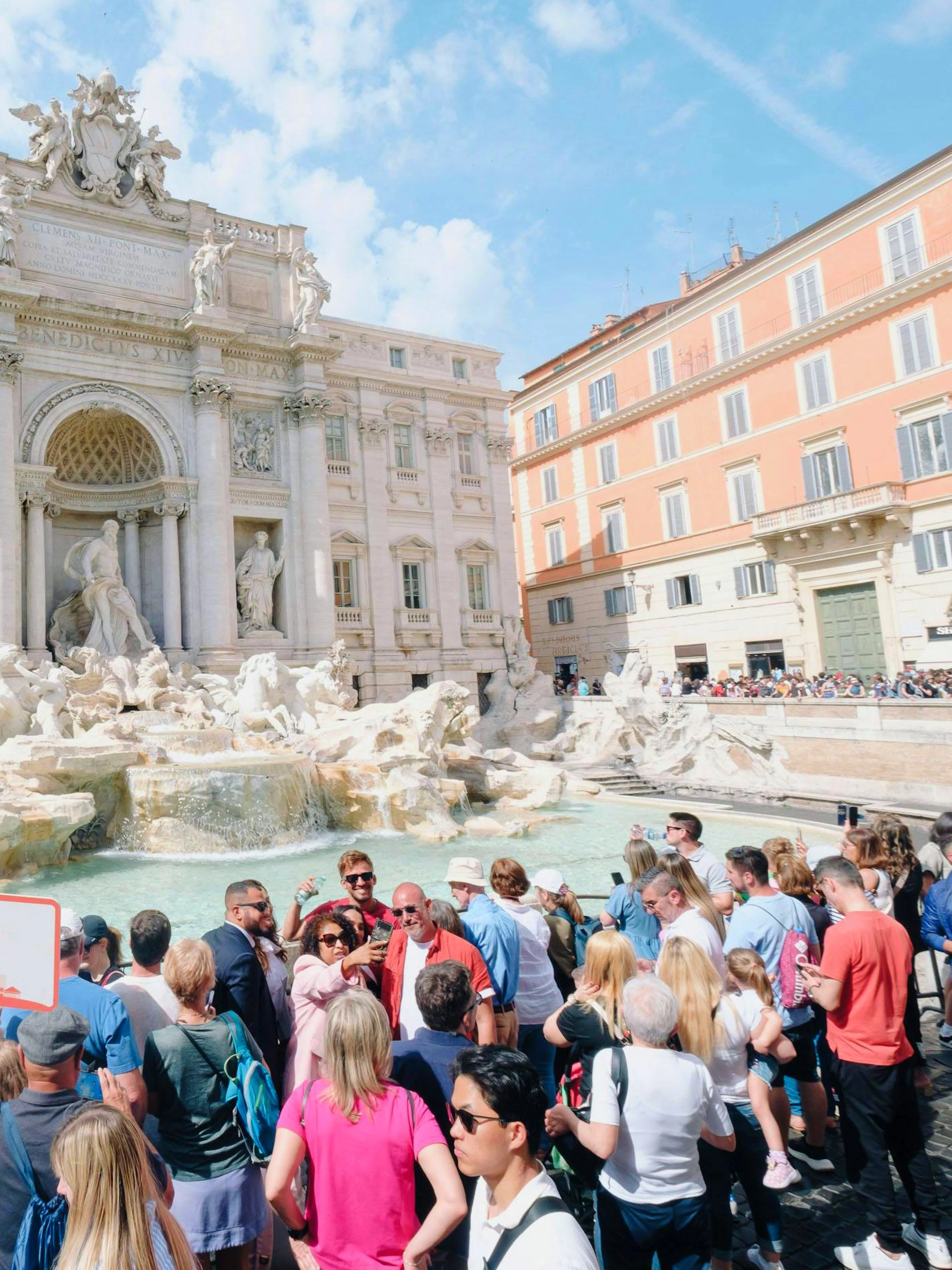 Crowd gathered at Trevi Fountain in Rome during Trevi District Underground guided tour.
