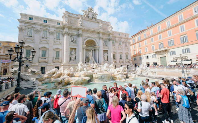 Crowd gathered at Trevi Fountain in Rome during Trevi District Underground guided tour.