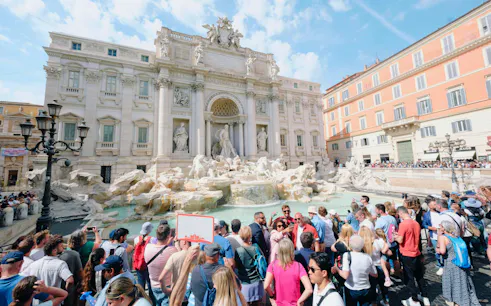 Crowd gathered at Trevi Fountain in Rome during Trevi District Underground guided tour.