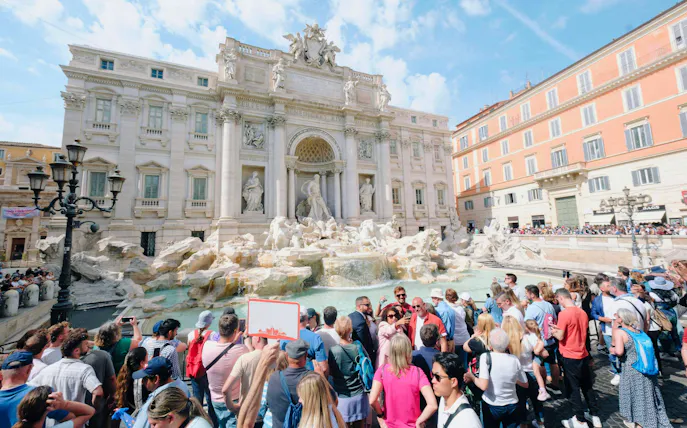 Crowd gathered at Trevi Fountain in Rome during Trevi District Underground guided tour.