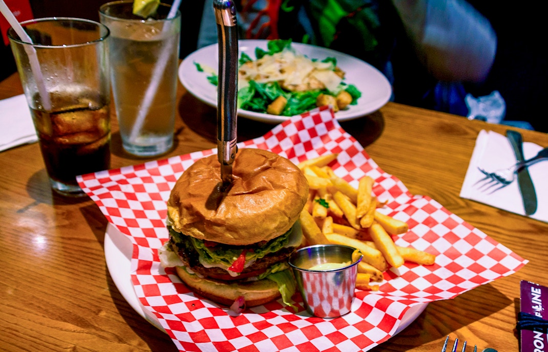 burger with fries on a plate, showcasing classic American cuisine.