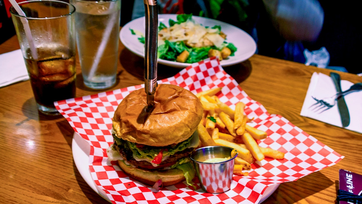 Hard Rock Cafe burger with fries on a plate, showcasing classic American cuisine.