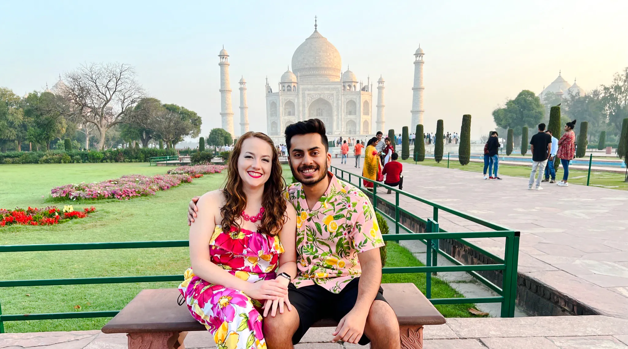 Couple sitting in front of the Taj Mahal during a private same-day tour from Delhi to Agra.