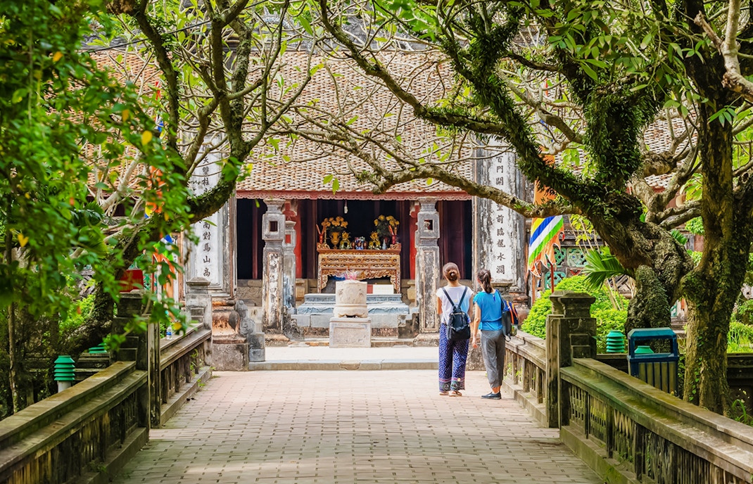 Entrance to Hoa Lư Ancient Capital with visitors in Ninh Bình, Vietnam.