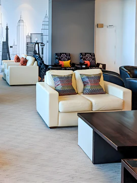 Plaza Premium Lounge Christchurch seating area with modern decor and cityscape mural.
