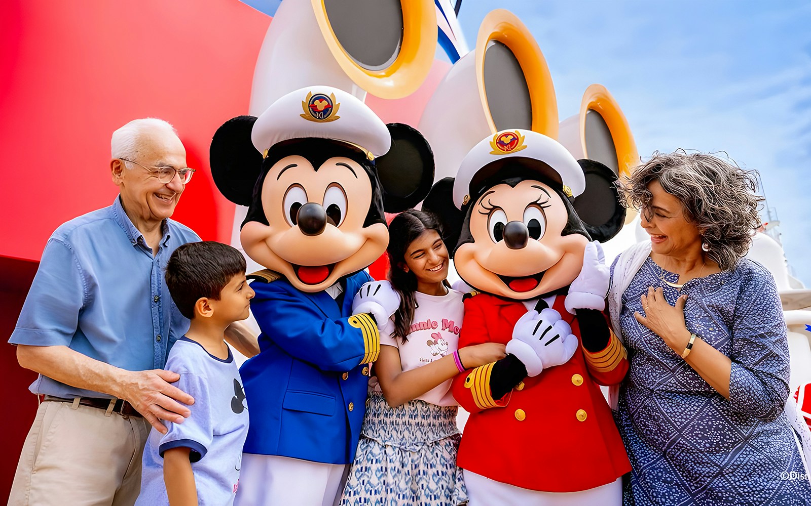 Mickey and Minnie Mouse meet and greet on Disney Adventure Cruise with family.