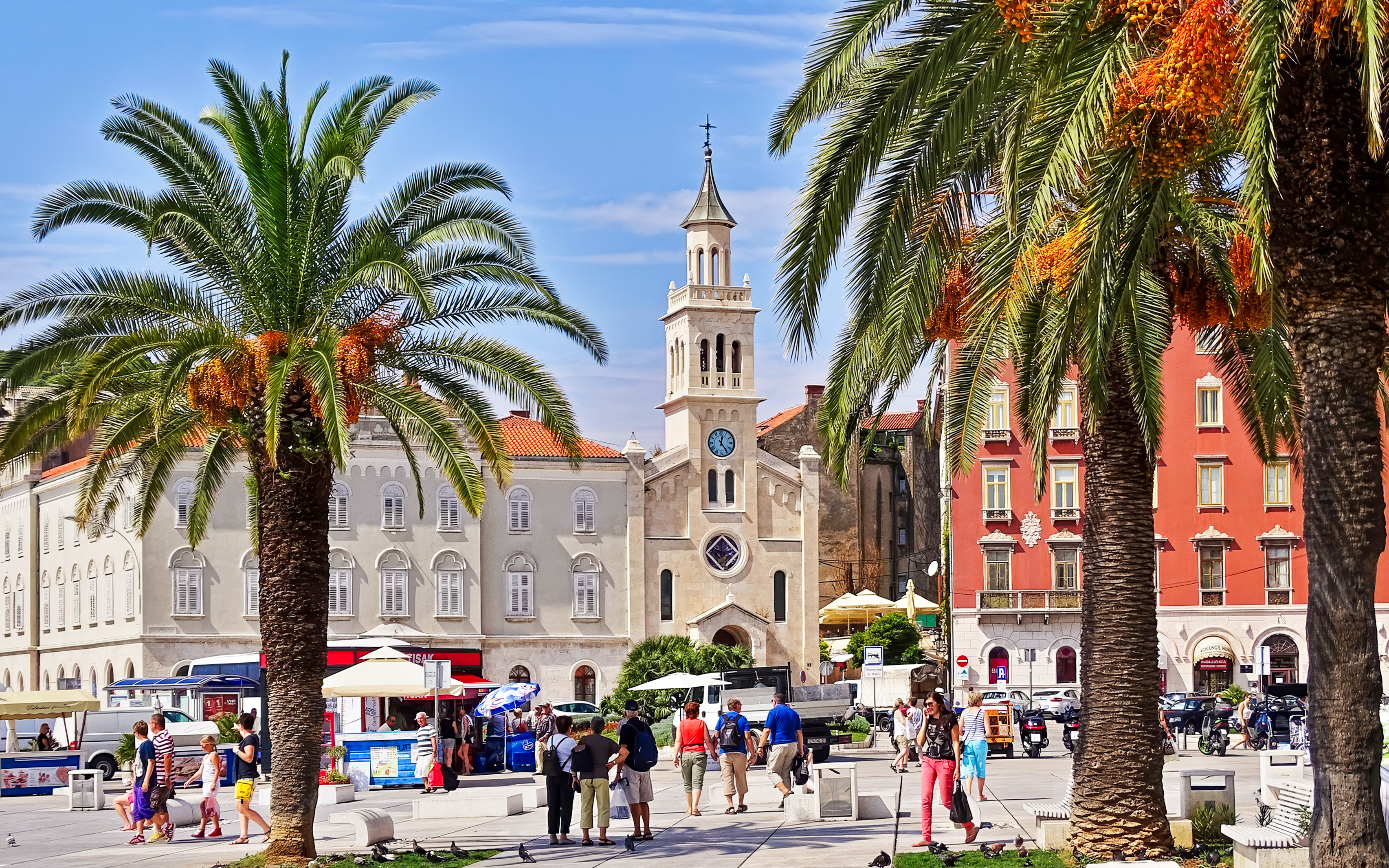 Riva Promenade with palm trees and historic buildings near Diocletian's Palace, Split, Croatia.