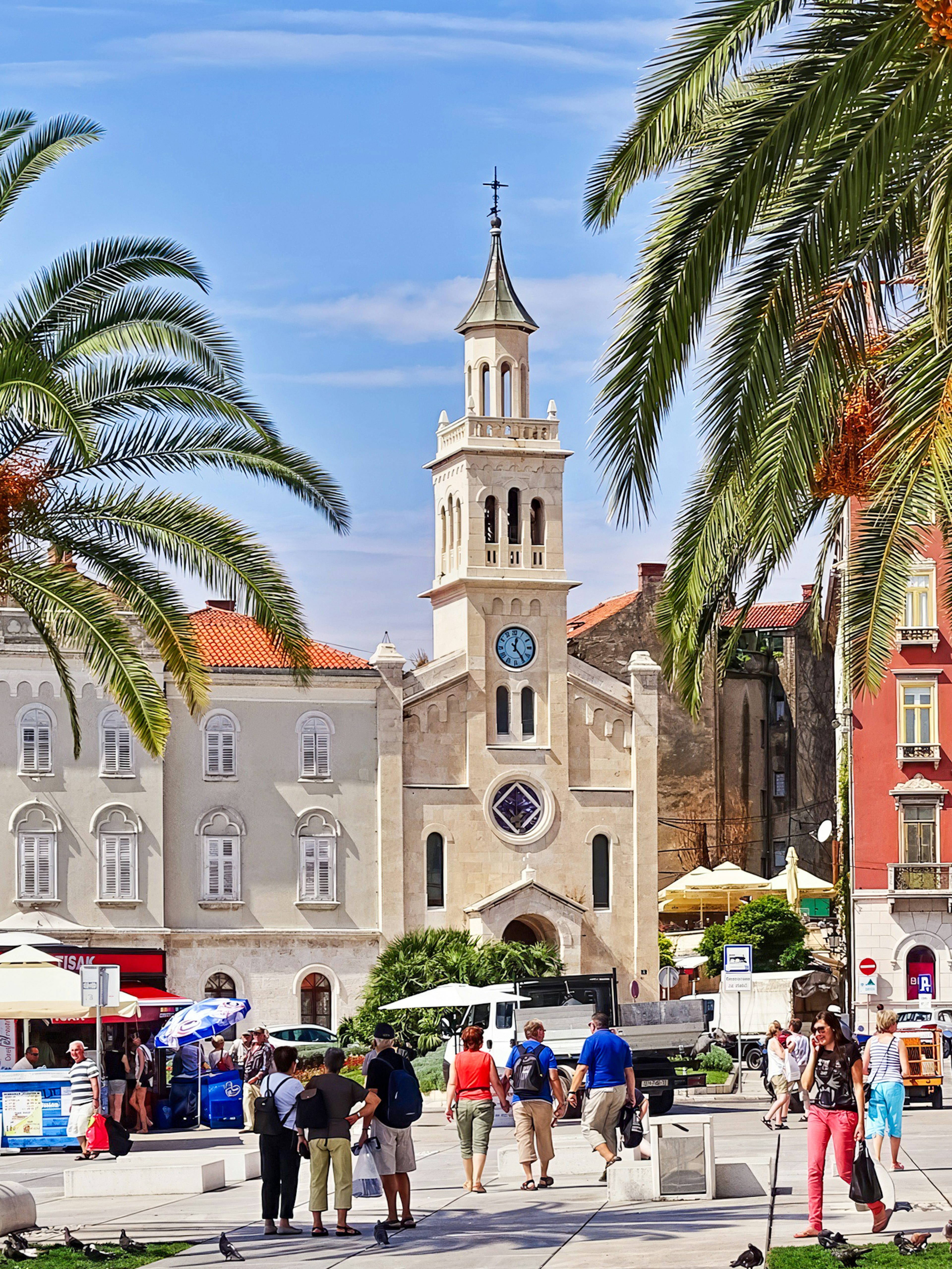 Riva Promenade with palm trees and historic buildings near Diocletian's Palace, Split, Croatia.