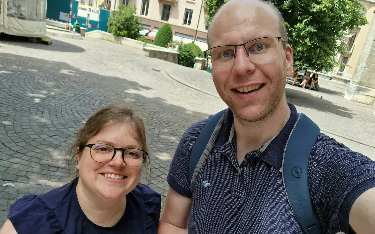 Self-guided tour participants exploring a historic square in Geneva.