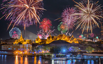Fireworks over Bangkok's Grand Palace at night, highlighting Promotion Group Saver Pack.