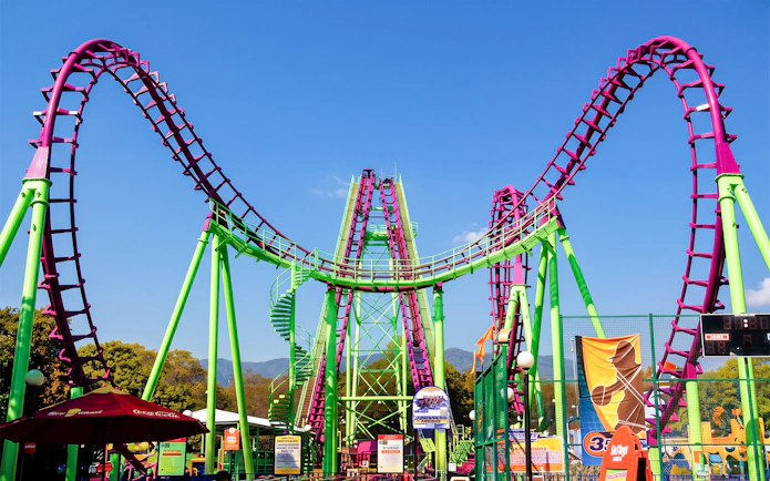 Rollercoaster at Six Flags Mexico with vibrant loops and green supports.