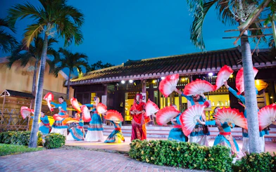 Performers with red fans at Hoi An Memories Show, Vietnam.