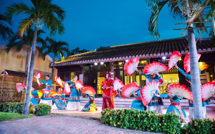 Performers with red fans at Hoi An Memories Show, Vietnam.