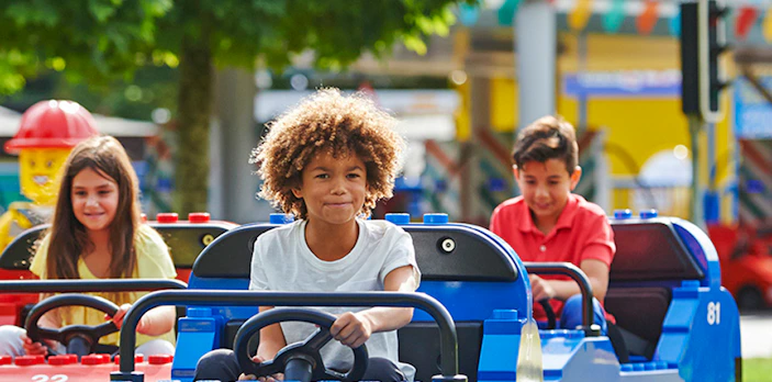 Children driving mini cars at Legoland Windsor.