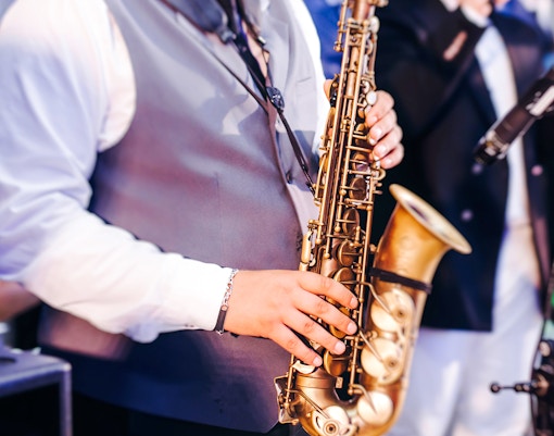 Musician playing saxophone at Paris Jazz Festival.