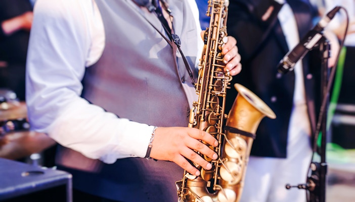 Musician playing saxophone at Paris Jazz Festival.
