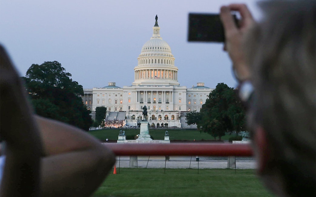 U.S. Capitol building at dusk viewed from a tour bus during a Big Bus 2-hour night tour.