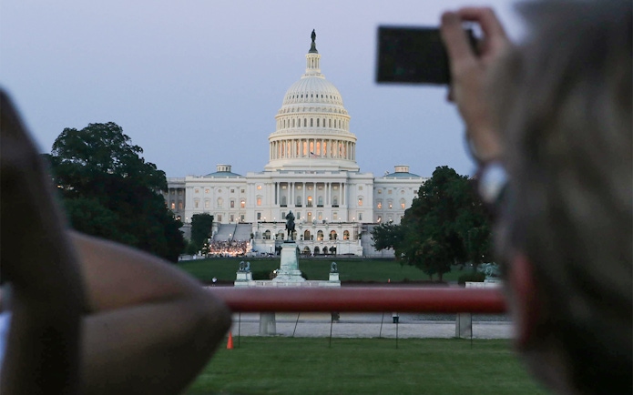 U.S. Capitol building at dusk viewed from a tour bus during a Big Bus 2-hour night tour.