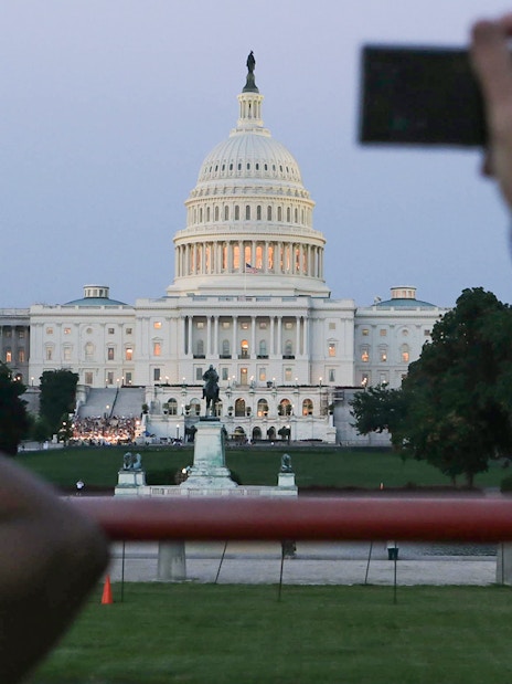 U.S. Capitol building at dusk viewed from a tour bus during a Big Bus 2-hour night tour.