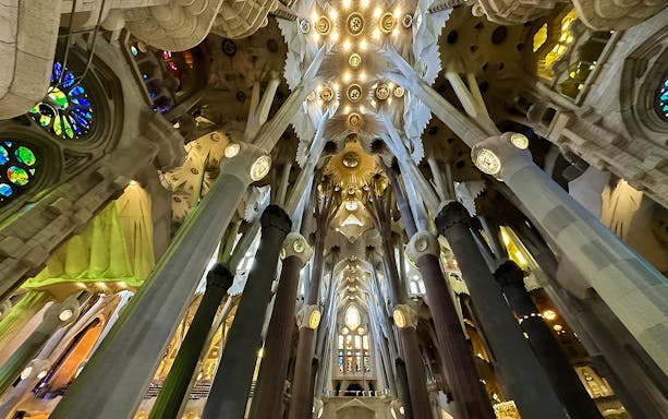 Interior view of Sagrada Familia's ceiling and columns in Barcelona.