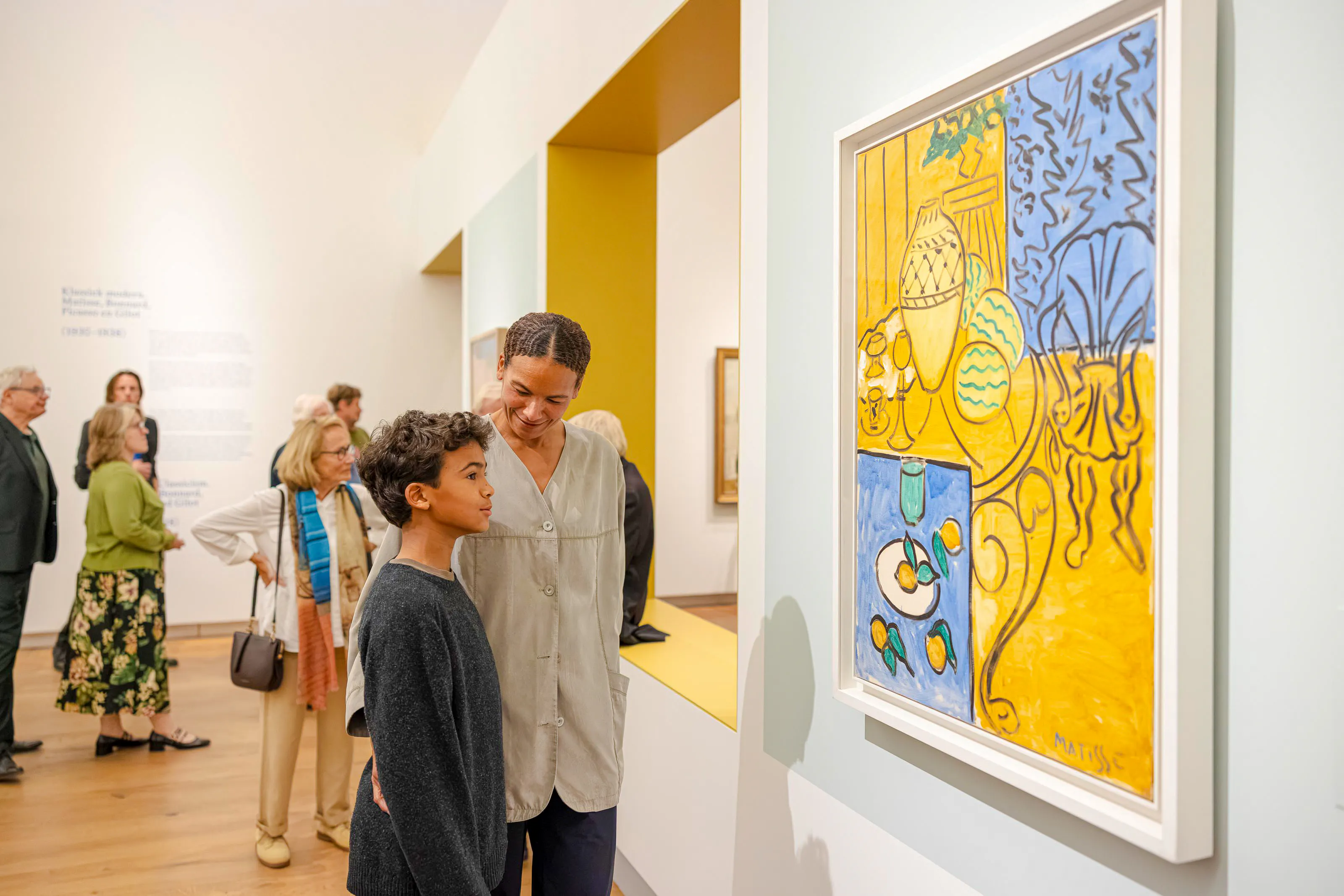 Visitors viewing Matisse painting at Chez Matisse exhibit, Amsterdam museum.