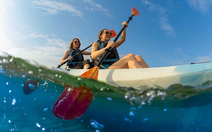 Tandem kayaking adventure on clear waters in Dubai.