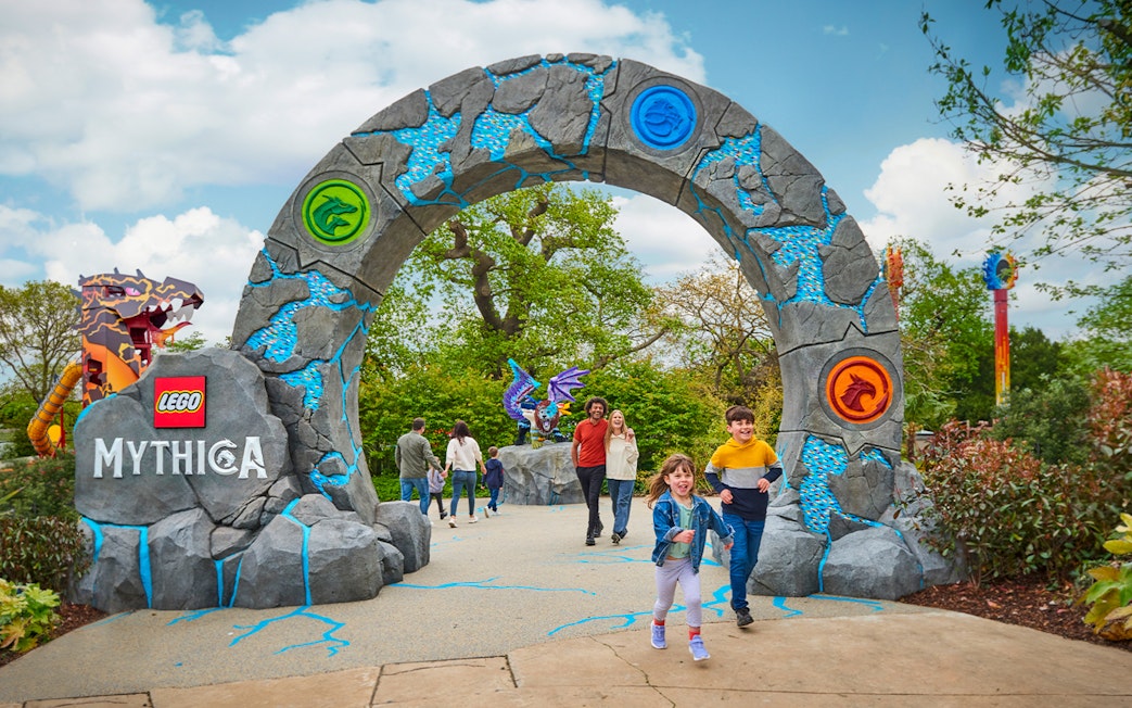 Entrance to LEGO MYTHICA at LEGOLAND® Windsor Resort with families walking through.