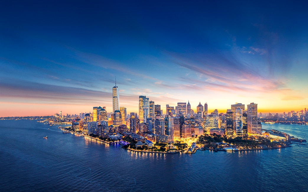 New York City skyline at sunset with One World Trade Center.