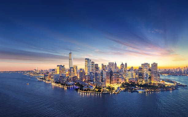 New York City skyline at sunset with One World Trade Center.