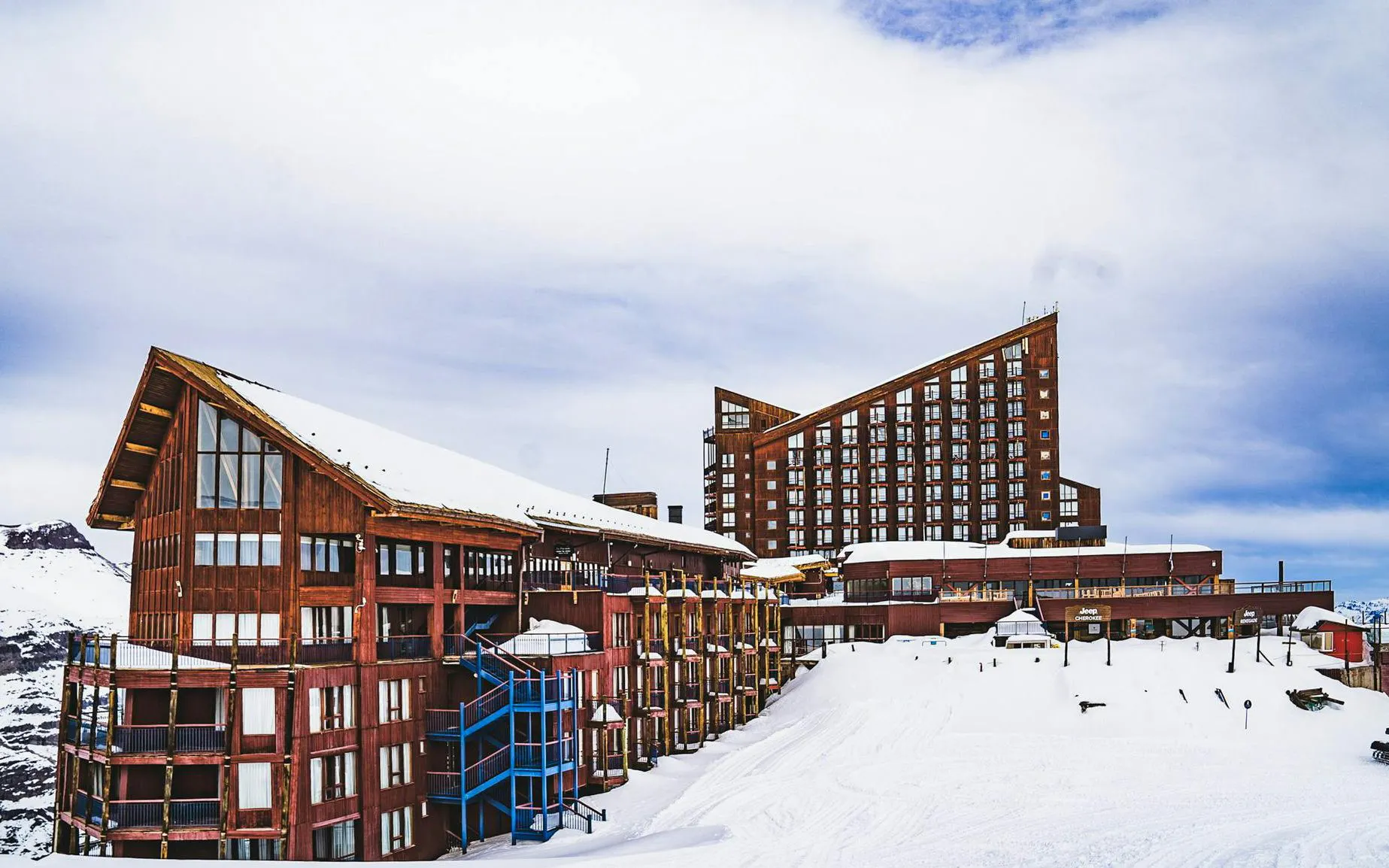 Hotel Puerta del Sol at Valle Nevado Ski Resort, Chile, surrounded by snow-covered mountains.
