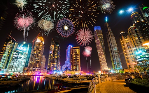 Fireworks over Dubai Marina skyline at night, UAE.