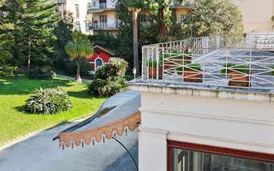 Villa Pignatelli garden view with terrace and greenery in Naples, Italy.