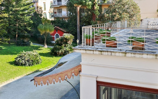 Villa Pignatelli garden view with terrace and greenery in Naples, Italy.