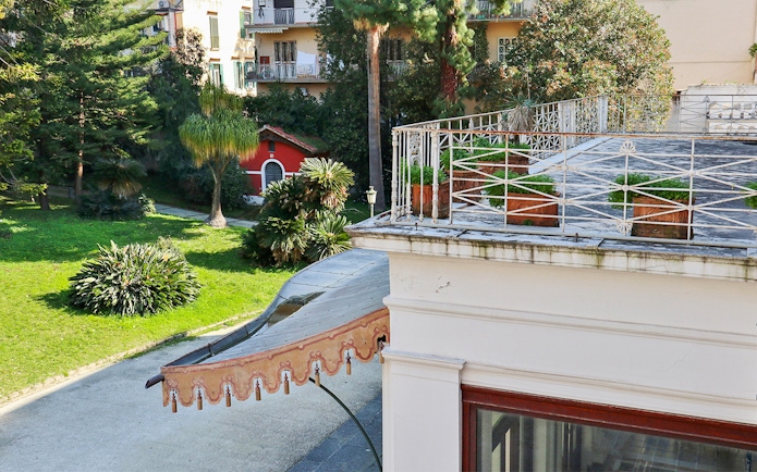 Villa Pignatelli garden view with terrace and greenery in Naples, Italy.