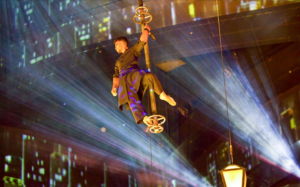 Performer suspended in air during La Perle by Dragone show in Dubai.