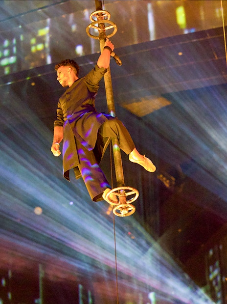Performer suspended in air during La Perle by Dragone show in Dubai.