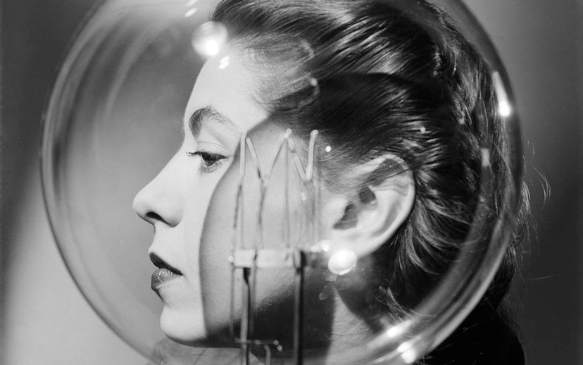 Profile of a woman with a lightbulb in front of her face.