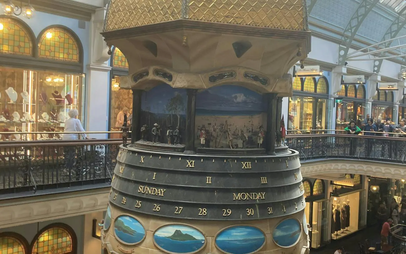 Clock tower inside Queen Victoria Building, Sydney, featuring historical dioramas.
