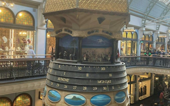Clock tower inside Queen Victoria Building, Sydney, featuring historical dioramas.