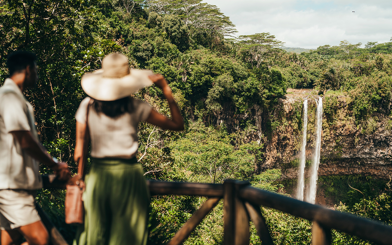 Visitors viewing Chamarel Waterfall on the 7 Coloured Earth plantation tour in Mauritius.